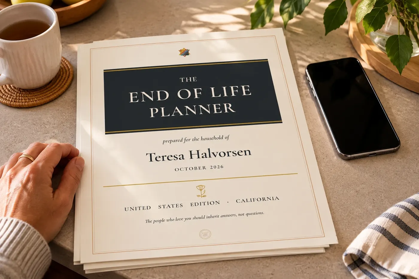 The printed planner beside a telephone on a kitchen counter