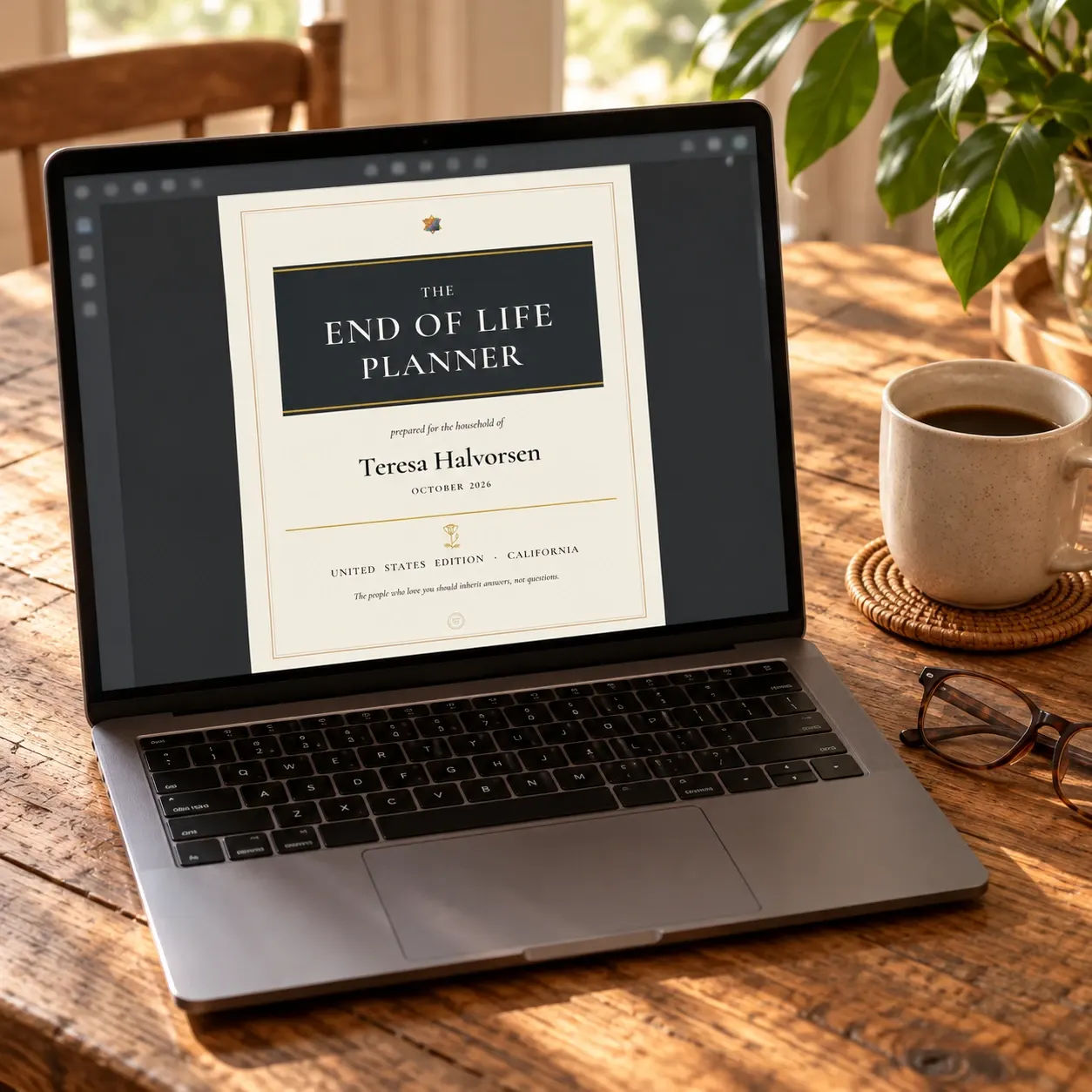 The planner's PDF open on a laptop beside a cup of coffee